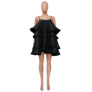 Detailed view of the elegant layered satin ruffles on this black tiered mini dress.