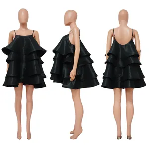 Macro view showing the tiered satin ruffles of this elegant black spaghetti strap dress