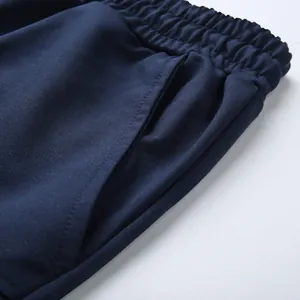 Close-up of side pocket and elastic waistband on navy blue cotton cargo shorts