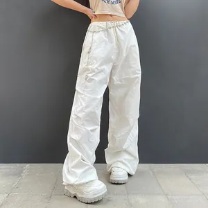 Styling detail of white wide-leg cargo pants with a silver heart-shaped chain belt
