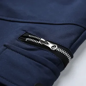 High-quality close-up detail of metal zipper and pocket stitching on navy cargo shorts