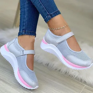 Close-up of grey and pink flyknit Mary Jane sneakers featuring a thick platform sole