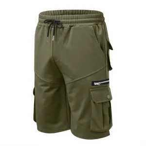 Detail view of army green cotton cargo shorts with multiple pockets and drawstring.