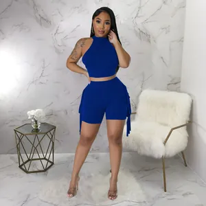 Detailed view of women's royal blue sleeveless crop top and matching fringe shorts set.