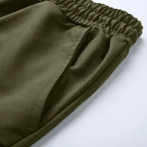 Detail shot of men's olive green cotton cargo shorts showing elastic waistband and pocket