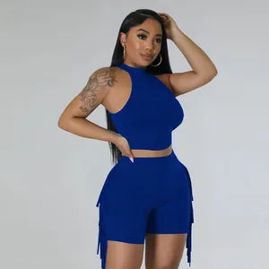 Detail of blue two-piece fashion set with sleeveless high-neck top and fringe shorts.