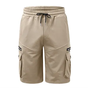 Front view detail of men's khaki cotton cargo shorts with zipper and flap pockets