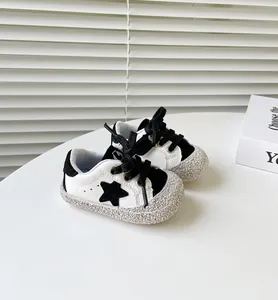 Detailansicht der schwarz-weißen Baby-Lauflernschuhe mit Sternmuster und weicher Sohle