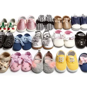 Collection of colorful infant walking shoes with bows, patterns, and cute designs