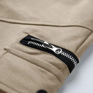 Close-up of high-quality metal zipper and durable cotton fabric on khaki cargo shorts