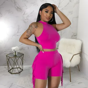 Close-up of pink sleeveless two-piece set featuring stylish side fringes on shorts
