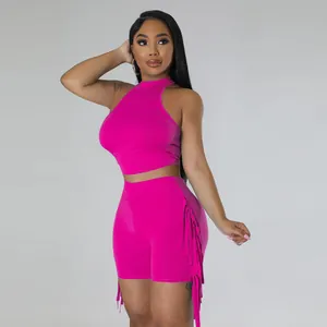 Vibrant fuchsia sleeveless high-neck crop top and fringe shorts two-piece set for women