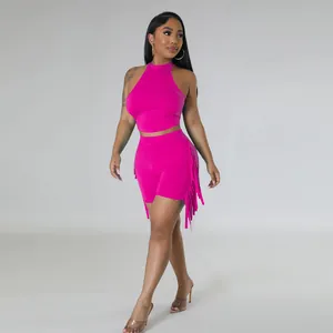 Detail view of hot pink fringe two-piece set with sleeveless halter top and shorts