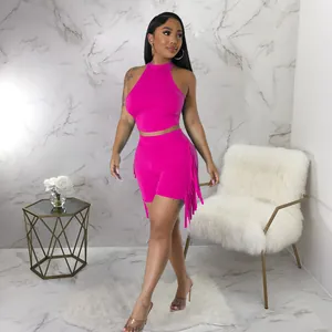 Vibrant hot pink sleeveless halter crop top and matching fringe detail shorts set