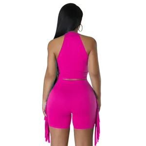 Back view of a vibrant pink sleeveless halter top and fringe shorts two-piece set.