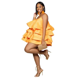 Full shot of a vibrant orange layered ruffle satin mini dress featuring spaghetti straps