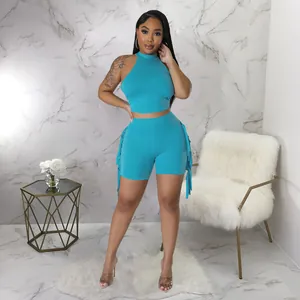 Stylish women sleeveless halter top and matching tassel shorts set in vibrant cyan blue