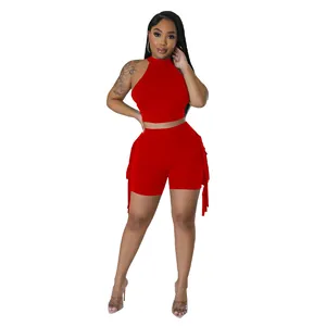 Detailed view of the red sleeveless halter neck crop top and fringe shorts two-piece set