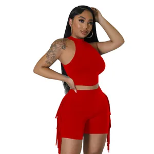 Full body model view of stylish red sleeveless halter crop top and fringe shorts outfit