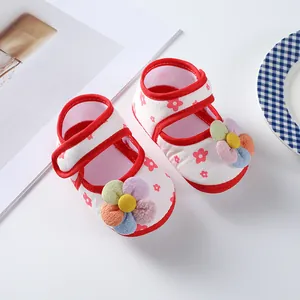 Close-up detail of soft sole baby girl princess shoes with a colorful fabric flower