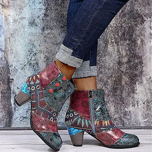 Vintage bunte Patchwork-Stiefeletten mit blauen Jeans vor einer rustikalen Texturwand
