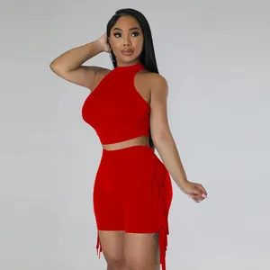 Sleeveless red two-piece set featuring a high-neck crop top and fringe detail shorts.