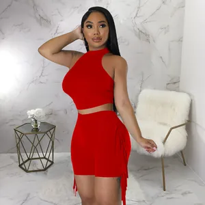 Side view of red two-piece set showing fringe detail and sleeveless crop top