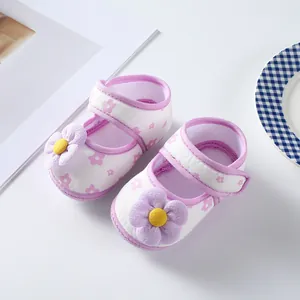 Close-up view of white and purple floral baby princess shoes with 3D flower detail