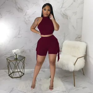 Detailed view of the burgundy two-piece set featuring side tassels on slim-fit shorts