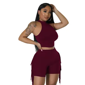 Detailed view of burgundy sleeveless high-neck crop top and fringe shorts two-piece set