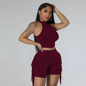 Two-piece sleeveless burgundy crop top and high waist shorts set with fringe details