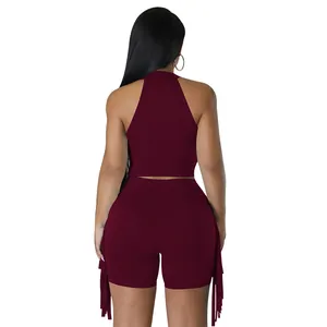 Back view of a sleeveless maroon two-piece set with side tassels and high waist shorts