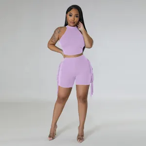 Detailed view of purple 2-piece set with sleeveless halter top and fringe shorts