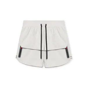 Detailed view of men's athletic shorts with black drawstrings and zipper pockets