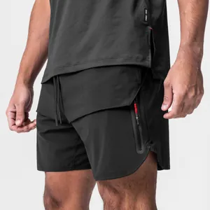Detail view of men's black athletic shorts with zipper pocket and drawstring
