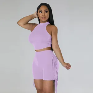 Detailed view of lavender two-piece set featuring fringe trim on shorts and sleeveless top.