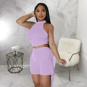 Close-up detail of the fringe design on lavender high-waisted shorts and crop top