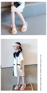 Close-up and lifestyle detail of girls white rhinestone bow sandals on an Asian child model