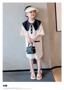 Detailed view of white rhinestone bow sandals on a young girl model.