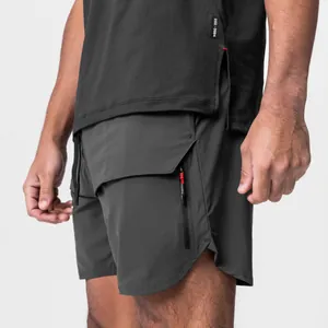Close-up of men's charcoal grey sports shorts featuring a red-detail zipper pocket