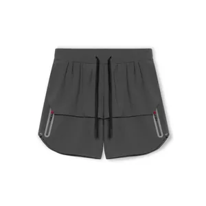 Detail view of mens grey athletic shorts with side zipper pockets and reflective strips