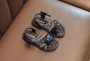 Top view of girls' black rhinestone bow sandals with soft quilted footbeds