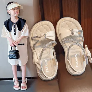 Elegant beige girl's sandals with sparkling rhinestones and cute bow details for summer