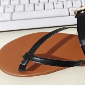 Detailed view of comfortable women's flat thong sandals with black adjustable buckle strap