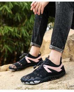 Detail of breathable outdoor hiking shoes with pink accents and non-slip soles.