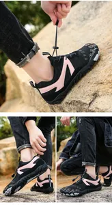 Detail of breathable non-slip outdoor hiking shoes with pink accents for men and women
