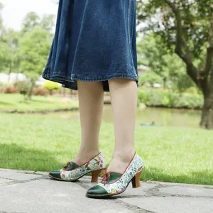 Side view of floral patchwork vintage pastoral high heels with wooden heels in garden