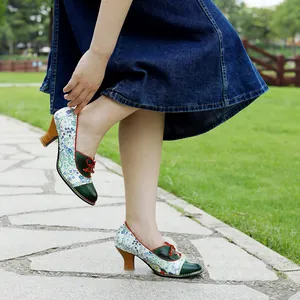 Floral patchwork vintage style high heels shown in a beautiful outdoor park scene