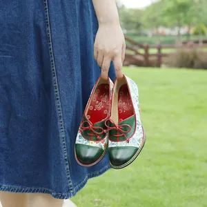 Floral patchwork vintage pastoral high heels held in a lush green garden setting
