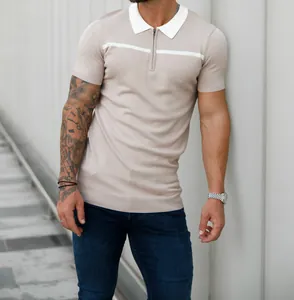 Close-up of slim fit men's beige knit polo shirt with white stripe and zipper detail.